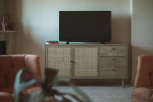 a television on a dresser in a living room at Agrikia Villa in Langadhákia