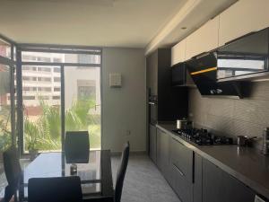 a kitchen with a table and a view at Golden Horn Apartment in Agadir