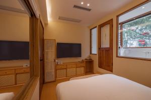 a bedroom with a bed and a flat screen tv at Chongqing Youwu Hotel -Jiefangbei in Chongqing