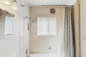a bathroom with a shower with a shower curtain at River View House in Springfield +18 photos