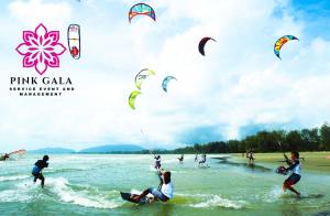 a group of people kite surfing in the water at Inap Homestay Kuantan - 5 minutes from Balok Beach by PG Management in Kampong Tanjong