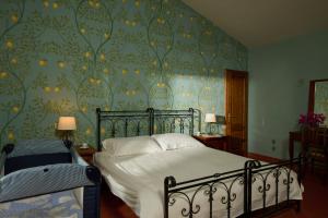 a bedroom with a bed with a floral wallpaper at La Lucertola in Pugnano +177 photos
