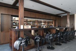 a bar with a row of chairs around it at Royal Horse Resort in Balkasodis