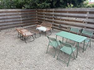 a group of tables and chairs and a fence at Le Clos Mignon in Besançon