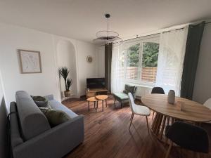 a living room with a couch and a table at Le Clos Mignon in Besançon