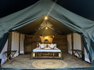 a bedroom in a tent with a bed at Kibo View Farm Lodge in Shiri