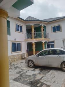 a car parked in front of a house at Great Peace & Love Hotel in Ashalaja