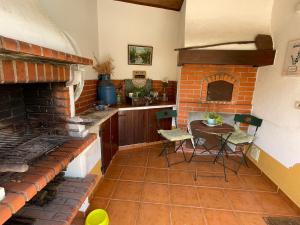a kitchen with a table and a brick oven at DEl Rey Guest House in Tomar