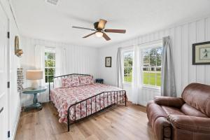 a bedroom with a bed and a ceiling fan at Chasing Sunsets by Coastline Vacation Rentals in Port Saint Joe