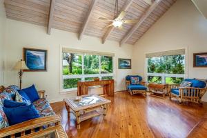 a living room with a couch and a table at Paradiso Hale in Princeville