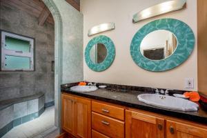 a bathroom with a sink and a mirror at Paradiso Hale in Princeville +27 photos