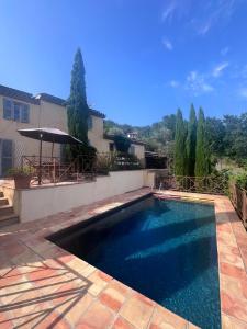 a swimming pool in the backyard of a house at Bargemon villa with modern interior and gorgeous view - with private pool and aircon in Bargemon