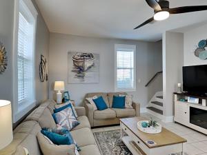 a living room with a couch and a tv at Bungalows at Seagrove #138 in Seagrove Beach