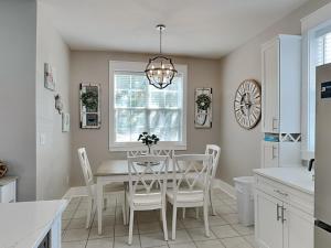 a kitchen with a dining room table and white chairs at Bungalows at Seagrove #138 in Seagrove Beach +25 photos