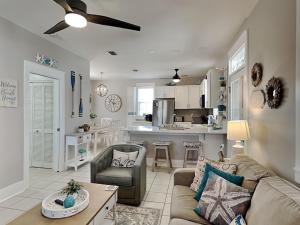 a living room with a couch and a kitchen at Bungalows at Seagrove #138 in Seagrove Beach