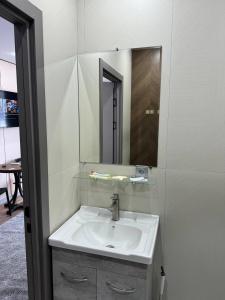 a bathroom with a sink and a mirror at Damir HOTEL ГОСТИНИЦА in Aktobe +51 photos
