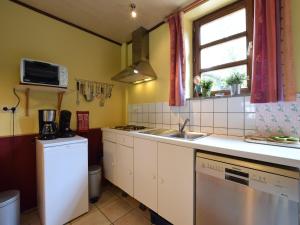 a small kitchen with a sink and a stove at Cozy Family Stay in Durbuy in Durbuy