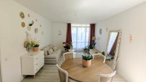 a living room with a table and a couch at Cosy Jungles - T3 - Balcon & parking gratuit in Pau +19 photos