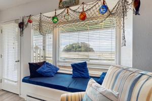 a window seat in a living room with blue pillows at Neskowin Resort Unit #203 in Neskowin