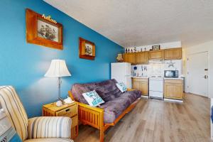 a living room with a couch and a kitchen at Neskowin Resort Unit #203 in Neskowin