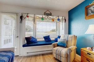 a window seat in a room with a couch and a chair at Neskowin Resort Unit #203 in Neskowin