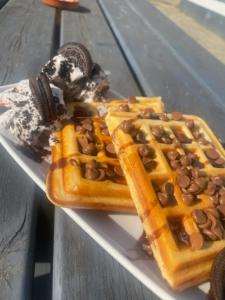 a plate with a waffle with chocolate chips and ice cream at the blue bell in Rothwell