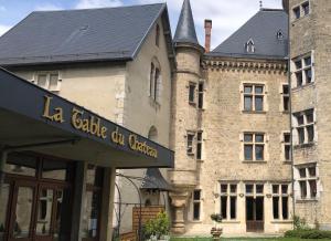 a large stone building with a sign in front of it at Chambre chez l'habitant in Saint-Geoire-en-Valdaine +8 photos