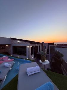 a swimming pool with two lounge chairs on a balcony at Jas Pipera Studio & Private Pool in Voluntari