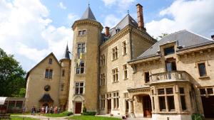 a large building with a tower on top of it at Chambre chez l'habitant in Saint-Geoire-en-Valdaine