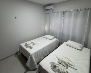 Ένα ή περισσότερα κρεβάτια σε δωμάτιο στο Sua Casa em Porto Nacional/TO. Wifi, Conforto, Localização