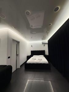 a bedroom with a bed in a room with a ceiling at Jas Pipera Studio & Private Pool in Voluntari +75 photos