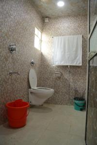 a bathroom with a toilet and a shower and a window at Dream House in Satara