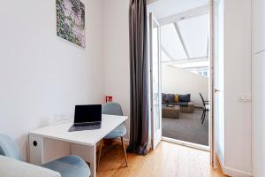 a white desk with a laptop on it in a living room at Piazza Venezia Suite and Terrace in Rome