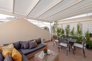 a living room with a blue couch and a table at Piazza Venezia Suite and Terrace in Rome