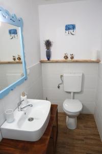 a bathroom with a white sink and a toilet at Casa Ivana Jurilovca in Jurilovca +31 photos
