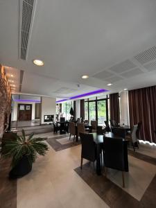 a restaurant with tables and chairs in a building at Vila Premiere Bistro-Spa in Piatra Neamţ