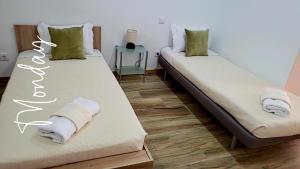 two beds in a room with towels on them at Villa Machado Chaves in Vila Nova da Veiga +17 photos