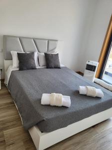 a bedroom with a large bed with towels on it at Villa Machado Chaves in Vila Nova da Veiga