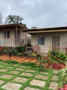 a house with a porch and a yard at Dream House in Satara