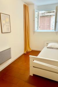 a bedroom with a bed and a window at Le nid Cévenol in Sumène +16 photos
