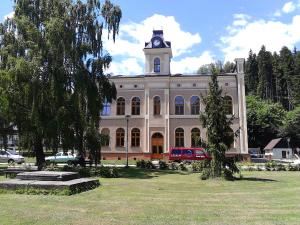 a large building with a clock tower on top of it at Šťastná třináctka in Svoboda nad Úpou