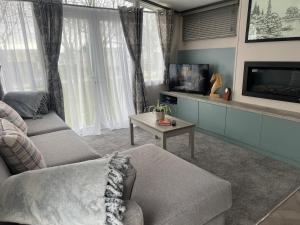 a living room with a couch and a tv at Neptune in Parkeston