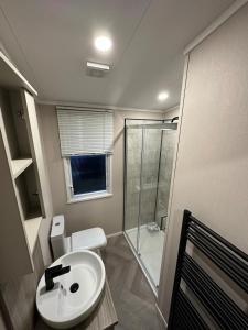 a bathroom with a toilet and a sink and a shower at Neptune in Parkeston +16 photos