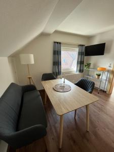 a living room with a table and a couch at Appartements Luna in Schladming