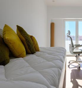 Ένα ή περισσότερα κρεβάτια σε δωμάτιο στο Almada Comfort