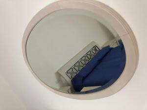 a circular stairwell with a round window with blue sheets at ApparTea in Marostica +7 photos