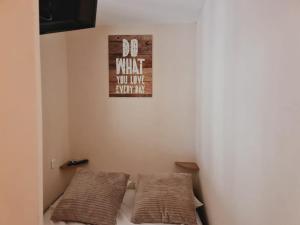 a room with two beds and a sign on the wall at Apartment with pool included in Agde