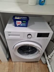 a white washing machine sitting under a counter at Apartment with pool included in Agde
