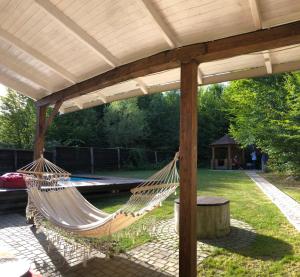 a patio with two hammocks under a pergola at Tre Sorelle in Migovo
