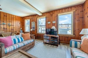 een woonkamer met een bank en een tv bij Crow's Nest K0380 in Nags Head